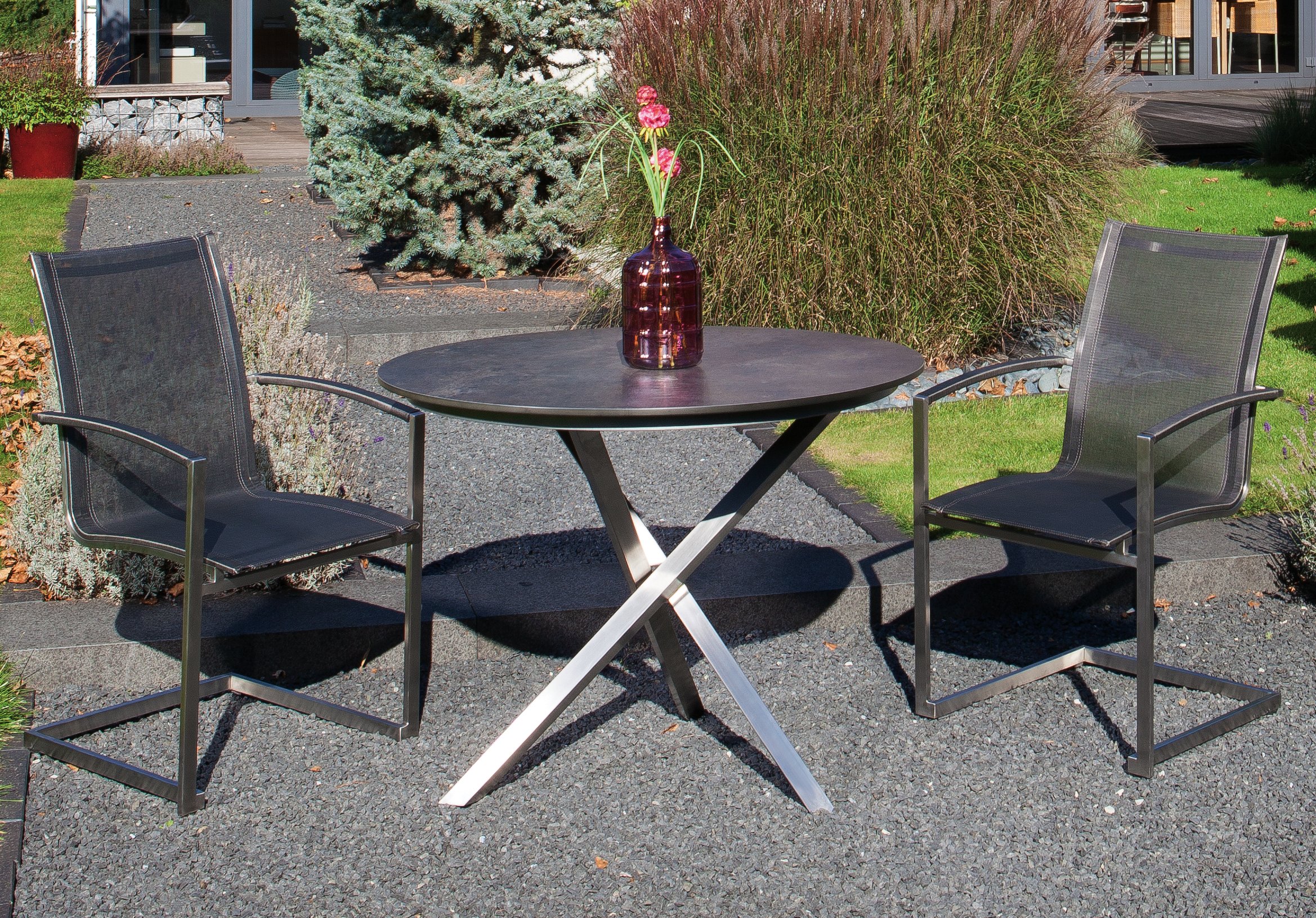 bequemer Freischwinger-Edelstahl-Gartenstuhl mit rundem Edelstahl-Gartentisch